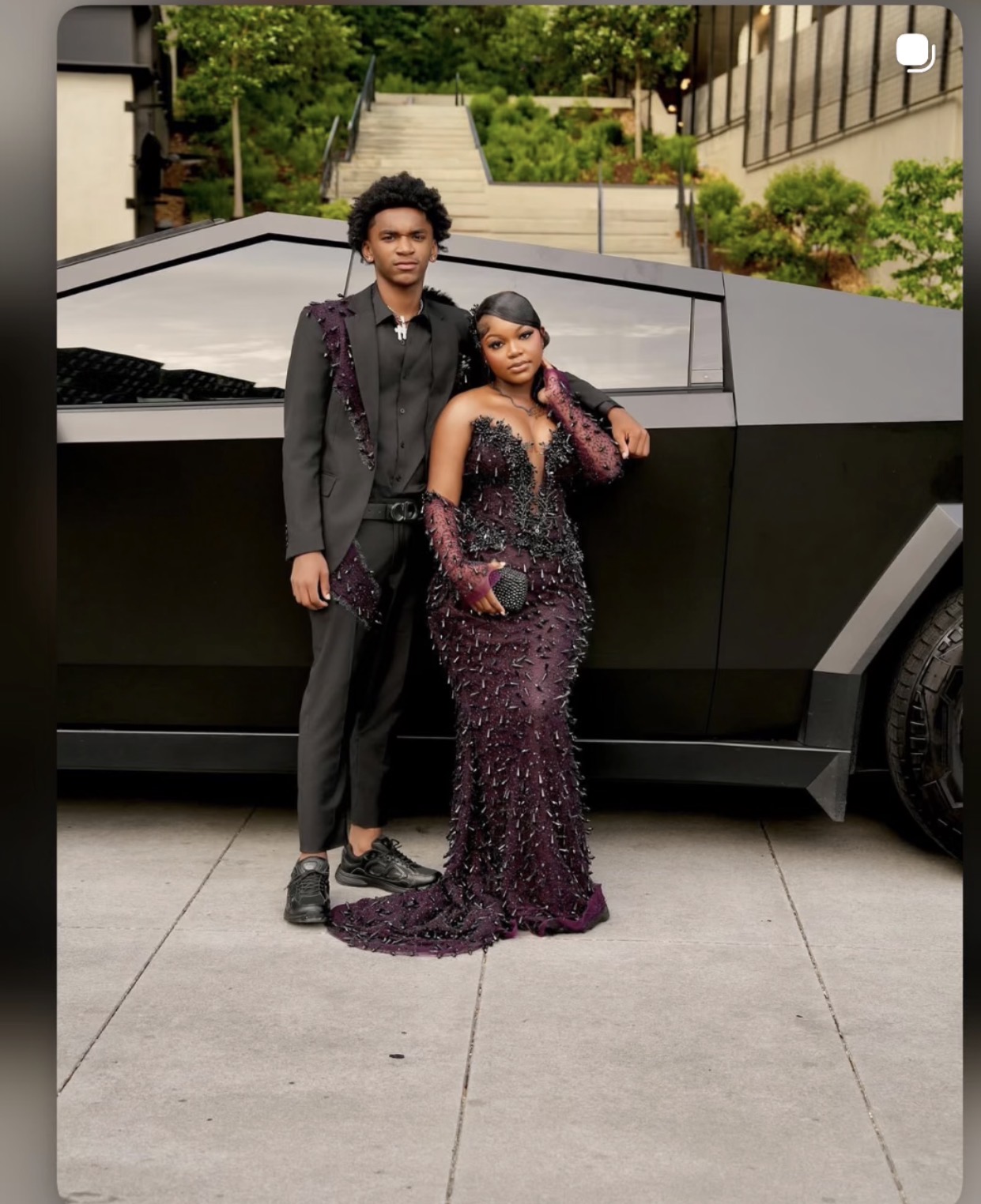 Prom couple in custom plum beaded gown